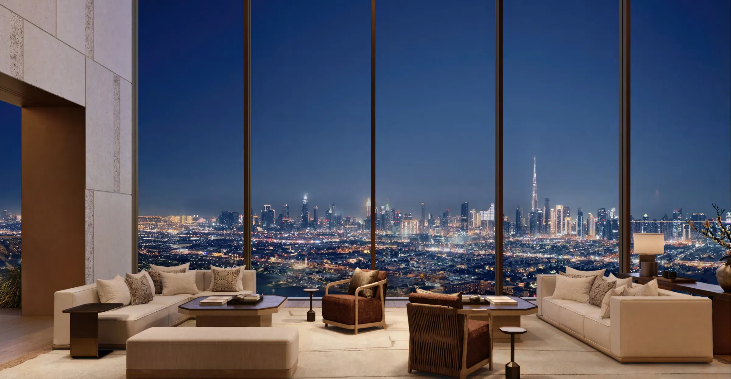 The same five-bedroom living room at night, with Burj Khalifa illuminated